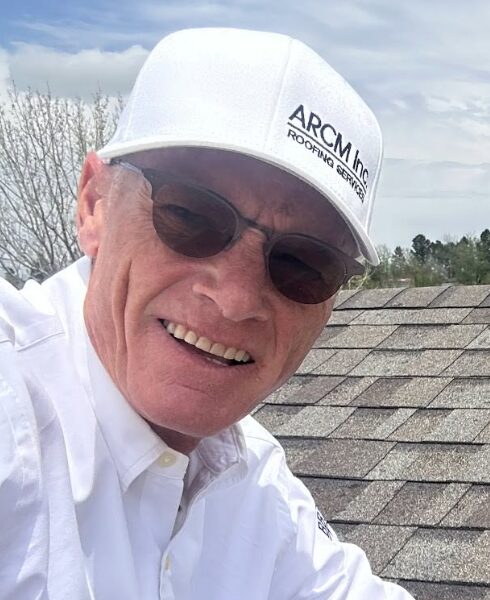 Anthony R. Hong, founder of ARCM Roofing Inc., on an asphalt shingle roof