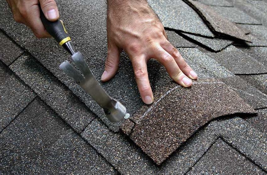 Technician sealing a roof leak at the source