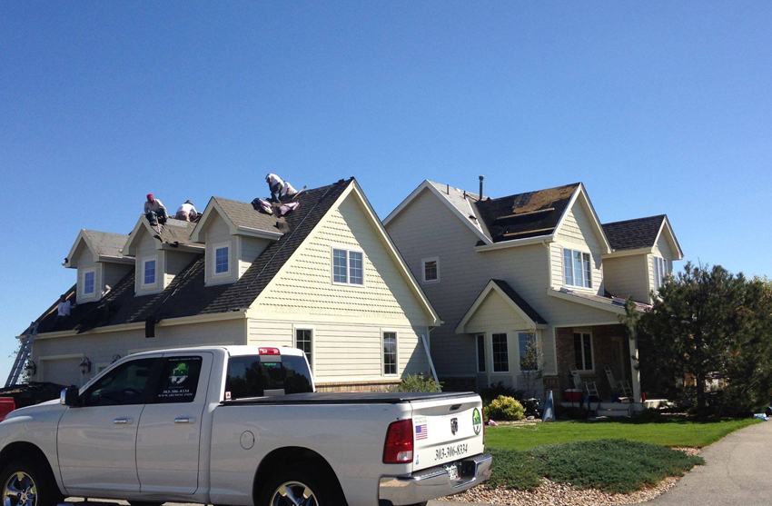 Moss and algae growth on aging roof shingles before cleaning