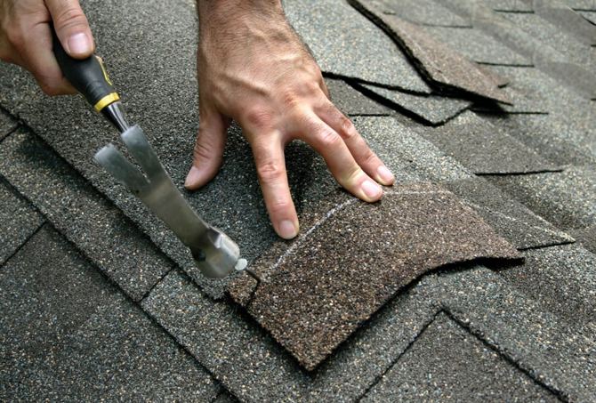 ARCM Roofing crew repairing an asphalt shingle roof